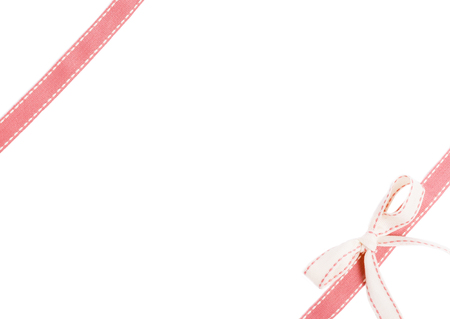 Pink ribbon with bow isolated on white backgroundの写真素材