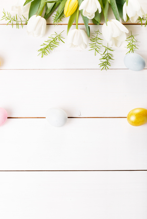Easter background with Easter eggs and spring flowers. Top view with copy spaceの写真素材