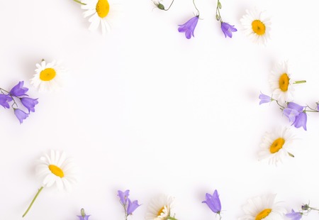 Mothers day card with with a bouquet of delicate wildflowers campanula on white wooden boardの写真素材