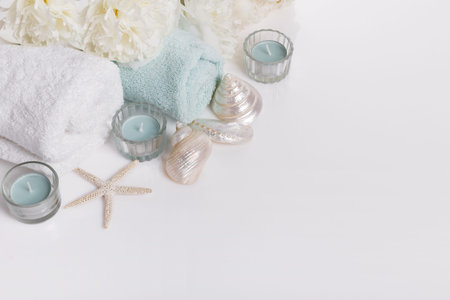 Spa gentle spring or summer background banner with peony flowers and seashells, candles