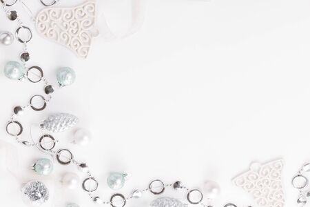 Christmas composition. Christmas white and silver decorations, on white background. Flat lay, top view, copy spaceの写真素材