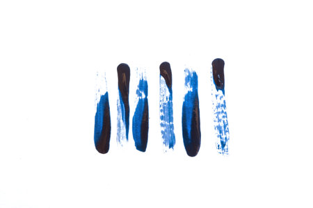 Color of the year 2020 classic blue. Strokes of nail polish on white paper texture