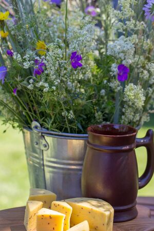 Bouquet of wild summer flowers, traditional latvian events Ligo. Composition with beer and cheeseの写真素材