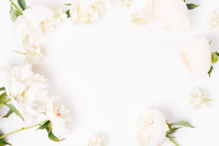 Flowers composition. Frame made of pink peony flowers on white background. Flat lay, top view, copy spaceの写真素材