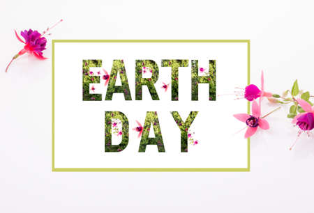 World earth day concept. Lettering Earth day with plants and wonderful flowersの写真素材