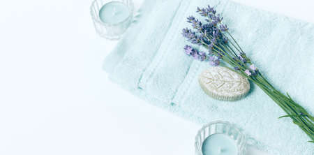 Spa background in pastel blue color, flat lay, towel, soap, lavander flowersの写真素材