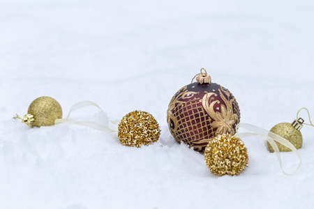Golden Christmas balls on snow background, Christmas bannerの写真素材