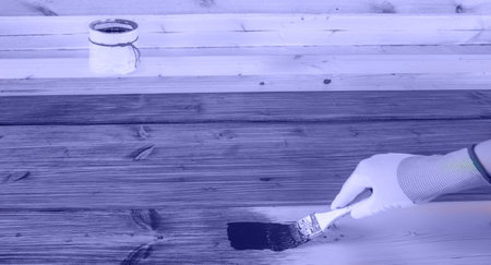 The process of painting wood surfaces with a brush.の写真素材