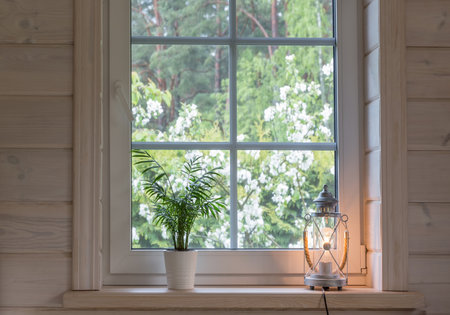 White window with mosuito net in a rustic wooden houseの写真素材