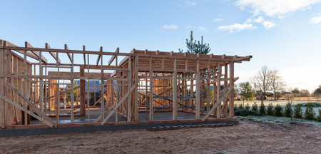 Wooden house frame construction on building site, sustainable architecture concept, eco friendly...