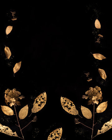 Golden autumn leaves and dry flowers with glitter dust on black background, vertical 4x5 format, elegant seasonal composition, decorative nature frame, magical sparkle concept, copy spaceの写真素材