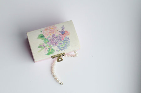 dangling pearls from a decorative jewelry boxの写真素材