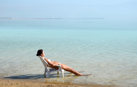 DEAD SEA, ISRAEL - November 25. Unknown girl resting on the shores of the Dead Sea, Israel, 11.25.2013のeditorial素材