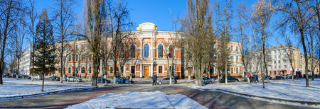 GOMEL, BELARUS - FEBRUARY 16, 2015: Unidentified people walk down street to Belorussian State University of Transport (previously - Men's classical gymnasium, 1898, architect S.Shabunevsky)のeditorial素材