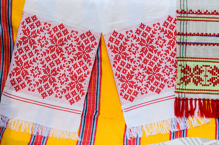 Belorussian towels with traditional ornaments on the background a bright colored rustic bedcoverの写真素材