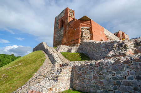 VILNIUS, LITHUANIA - JULY 10, 2015: Unknown girl inspects the ruins of Upper Vilnius Castle,...