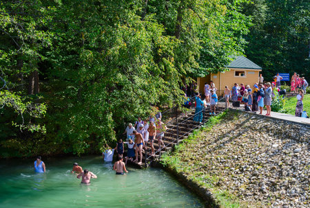 TSYGANOVKA, RUSSIA - AUGUST 22, 2015: Unknown pilgrims are dipping in water on the holy source in the name of St. Seraphim of Sarov near the village Tsyganovka, Russiaのeditorial素材