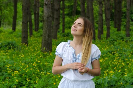 Portrait of a beautiful young woman in the forestの写真素材