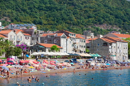 PETROVAC, MONTENEGRO - SEPTEMBER 19, 2015: Unidentified people are relaxing on beach in popular resort town of Petrovac, Montenegroのeditorial素材
