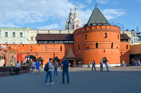 MOSCOW, RUSSIA - JULY 23, 2016: Unidentified people walk on Theater Square near famous prestigious restaurant "Old Tower" which is located in ancient tower China- city wall. In background - Savior Cathedral of Zaikonospassky monasteryのeditorial素材
