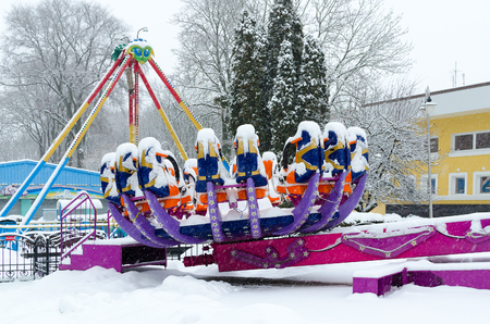 GOMEL, BELARUS - JANUARY 12, 2017: Snow-crowned attraction "Zodiac" in winter park during snowfall, Gomel, Belarusのeditorial素材