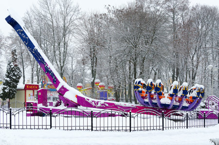 GOMEL, BELARUS - JANUARY 12, 2017: Snow-crowned attraction "Zodiac" in winter park during snowfall, Gomel, Belarusのeditorial素材