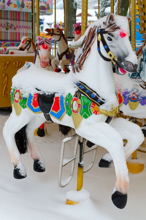 GOMEL, BELARUS - JANUARY 12, 2017: Snowy carousel "Horses" in winter park during snowfall, Gomel, Belarusのeditorial素材