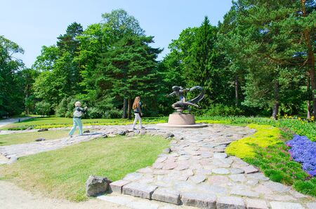 PALANGA, LITHUANIA - JULY 12, 2015: Unidentified tourists are near sculpture "Egle - Queen of snakes" in Botanical park in Palanga, Lithuaniaのeditorial素材