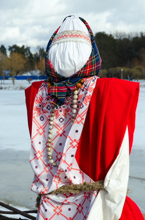 Shrovetide doll in colorful costume outdoorsの写真素材