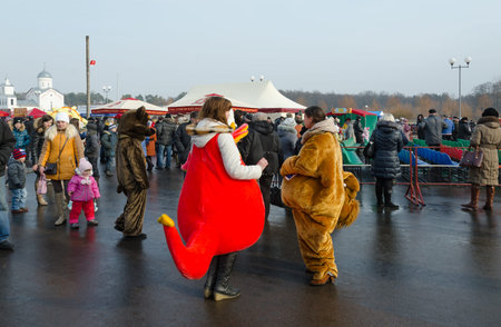 GOMEL, BELARUS - FEBRUARY 21, 2015: Growth dolls at Shrovetide festivities. Unidentified people visit festive event in Pancake Dayのeditorial素材