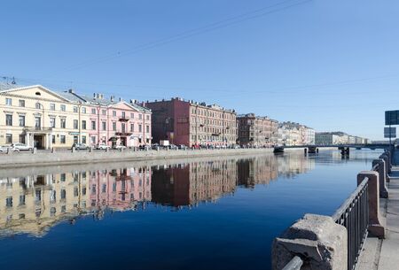 SAINT PETERSBURG, RUSSIA - MAY 2, 2017: View of Gorstkin Bridge and embankment of Fontanka River with reflections of buildings in water, St. Petersburg, Russiaのeditorial素材