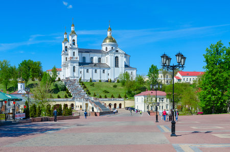 VITEBSK, BELARUS - MAY 23, 2017: Unidentified people go on Pushkin bridge in the direction of Holy Dormition Cathedral and Holy Spirit convent, Vitebsk, Belarusのeditorial素材