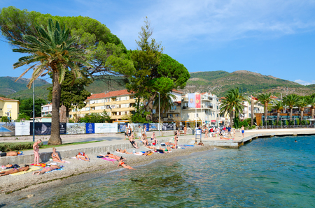 TIVAT, MONTENEGRO - SEPTEMBER 10, 2017: Unknown people rest on beach on seafront of popular resort town of Tivat, Montenegroのeditorial素材