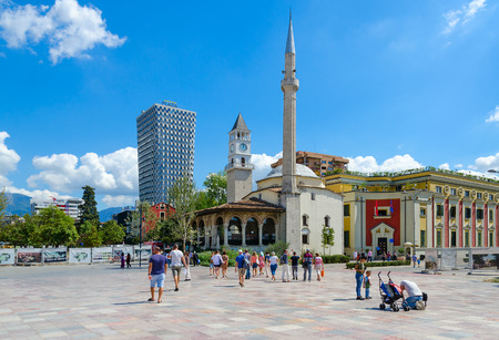 TIRANA, ALBANIA - SEPTEMBER 6, 2017: Group of unknown tourists on Skanderbeg Square. Efem Bay Mosque, Clock Tower, Plaza Hotel, Tirana, Albaniaのeditorial素材