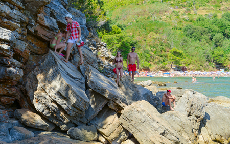 BUDVA, MONTENEGRO - SEPTEMBER 7, 2017: Unknown tourists go on huge rocks from Mogren beach to cliff with view point, Budva, Montenegroのeditorial素材