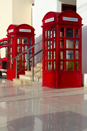 SHARM EL SHEIKH, EGYPT - MAY 9, 2018: Red telephone booths in British style in popular shopping and entertainment area Soho Square, Sharm El Sheikh, Egyptのeditorial素材