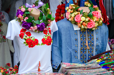 VITEBSK, BELARUS - JULY 13, 2016: Street trading at popular annual festival Slavic Bazaar in Vitebsk. Clothing with embroidery stitch, multicolored shawlsのeditorial素材