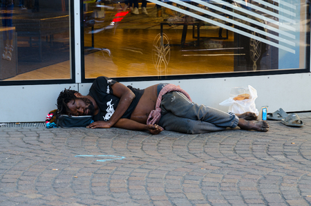 PARIS, FRANCE - SEPTEMBER 7, 2018: Unknown homeless dark-skinned man is sleeping on street of Paris, Franceのeditorial素材
