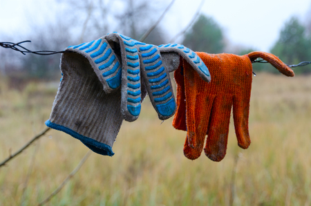 Dirty work gloves hanging on barbed wire in Chernobyl NPP Exclusion Zone, Ukraineの写真素材