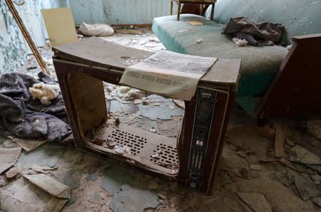 PRIPYAT, UKRAINE - NOVEMBER 11, 2018: Frame of old TV "Slavutich" on floor among trash in rest room in hospital No. 126, dead ghost town of Pripyat in Chernobyl NPP alienation zone, Ukraineのeditorial素材