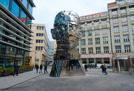 PRAGUE, CZECH REPUBLIC - JANUARY 25, 2019: Unidentified people walk along street near sculptural composition Franz Kafka Head, Prague, Czech Republicのeditorial素材