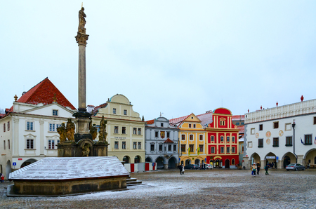 CESKY KRUMLOV, CZECH REPUBLIC - JANUARY 24, 2019: Column of Virgin Mary, or Plague pillar, on main square (Namesti Svornosti) of historic center. Unknown people walk around squareのeditorial素材