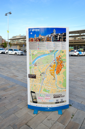GIRONA, SPAIN - SEPTEMBER 11, 2018: Stand with tourist map of city near bus station and railway station, Girona, Spainのeditorial素材