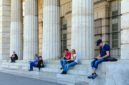 VIENNA, AUSTRIA - SEPTEMBER 17, 2018: Unknown people rest on steps near columns of Portal of Heroes (External fortress gates, Burgtor), Vienna, Austriaのeditorial素材