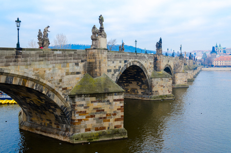 PRAGUE, CZECH REPUBLIC - JANUARY 22, 2019: View of famous medieval Charles Bridge on cloudy January morning. Unknown woman walks over bridgeのeditorial素材