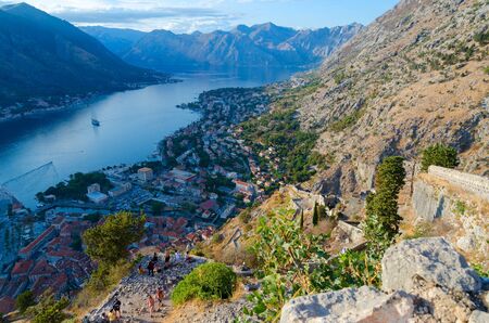 KOTOR, MONTENEGRO - SEPTEMBER 8, 2017: Unknown tourists are at ancient fortress walls above Kotor and Bay of Kotor, Montenegroのeditorial素材