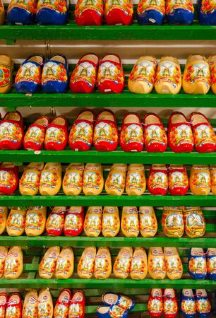 AMSTERDAM, NETHERLANDS - SEPTEMBER 6, 2018: Traditional Dutch wooden shoes (klompy) on shelves in souvenir shop, Amsterdam, Netherlandsのeditorial素材