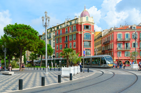 NICE, FRANCE - SEPTEMBER 15, 2018: Modern high-speed tram on Place Massena, Nice, Cote d'Azur, France. Unknown people walk down streetのeditorial素材
