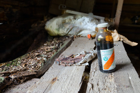 POGONNOE, BELARUS - JULY 4, 2020: Dirty glass bottle of ferrogluconate in former veterinary laboratory in resettled village of Pogonnoe in Chernobyl exclusion zone, Belarusのeditorial素材