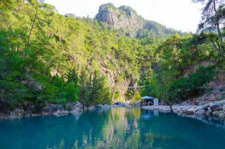 Beautiful view of mountain lake surrounded by tree-covered mountain slopes in Goynuk Canyon, Turkeyの写真素材
